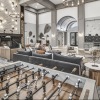 a clubroom with a foosball table and a couch
