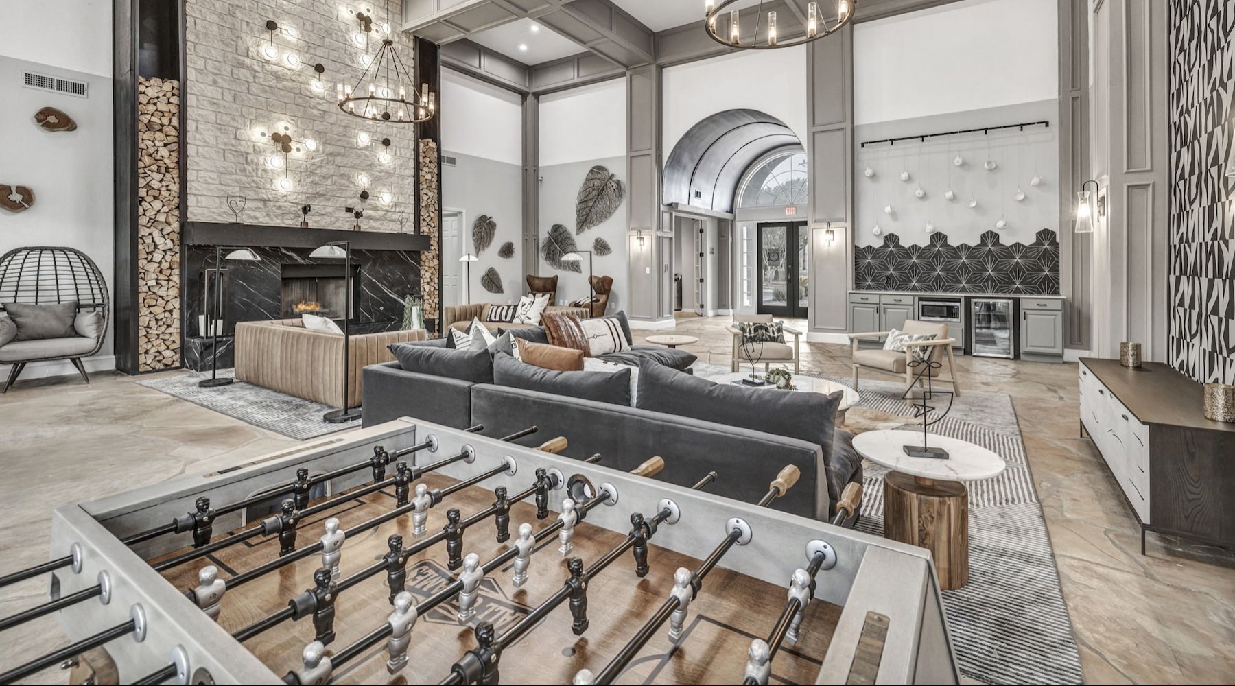 a clubroom with a foosball table and a couch