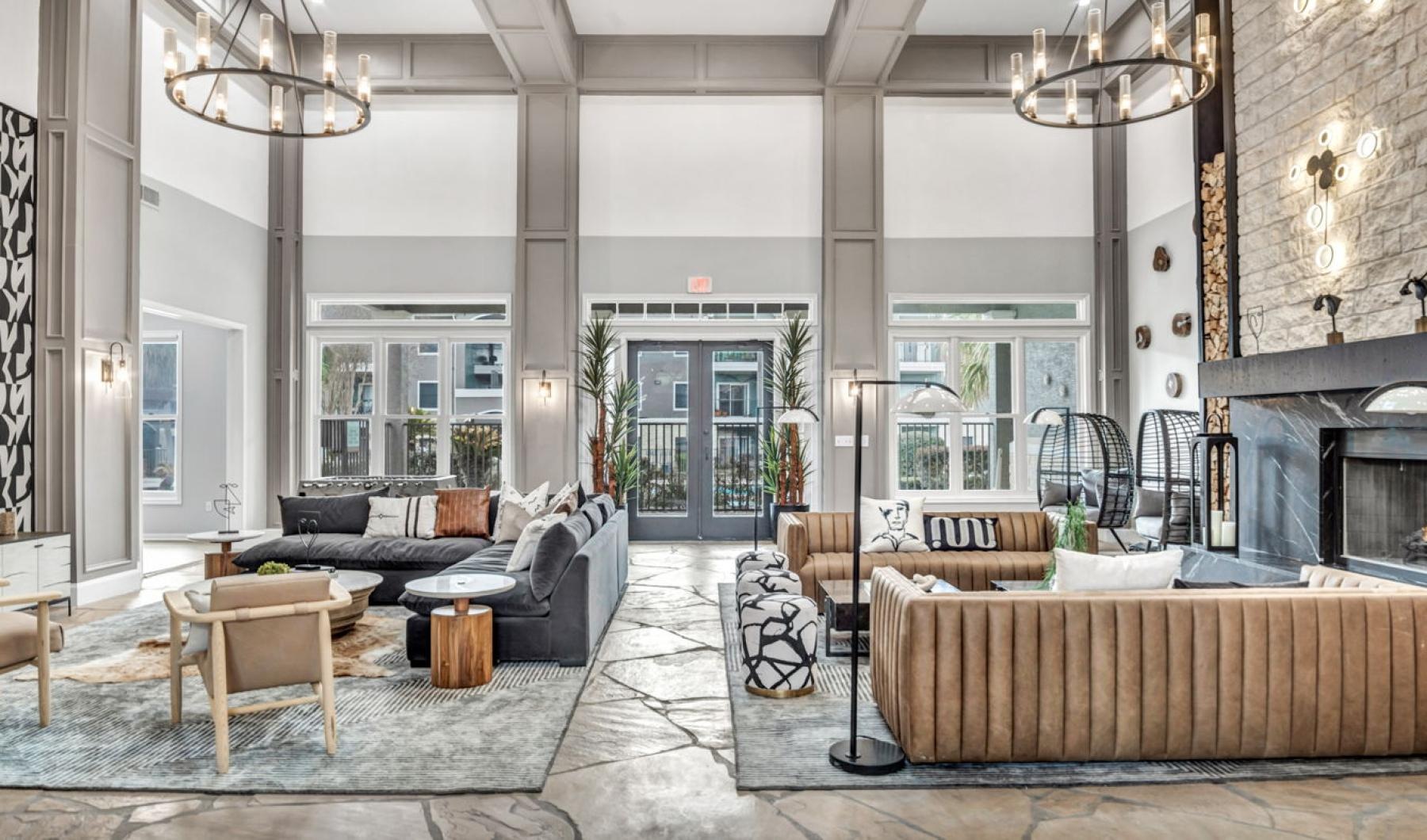 a clubroom with couches and a fireplace